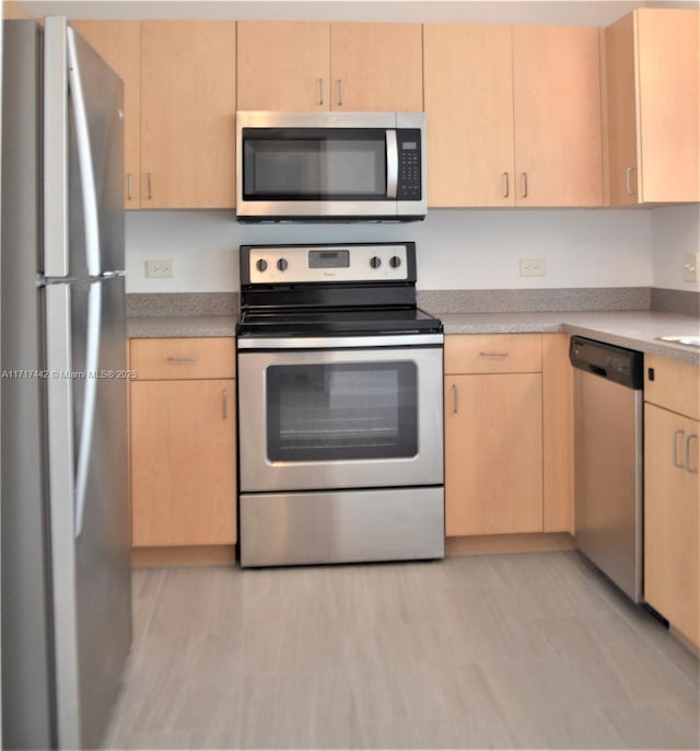 kitchen featuring light brown cabinetry and stainless steel appliances