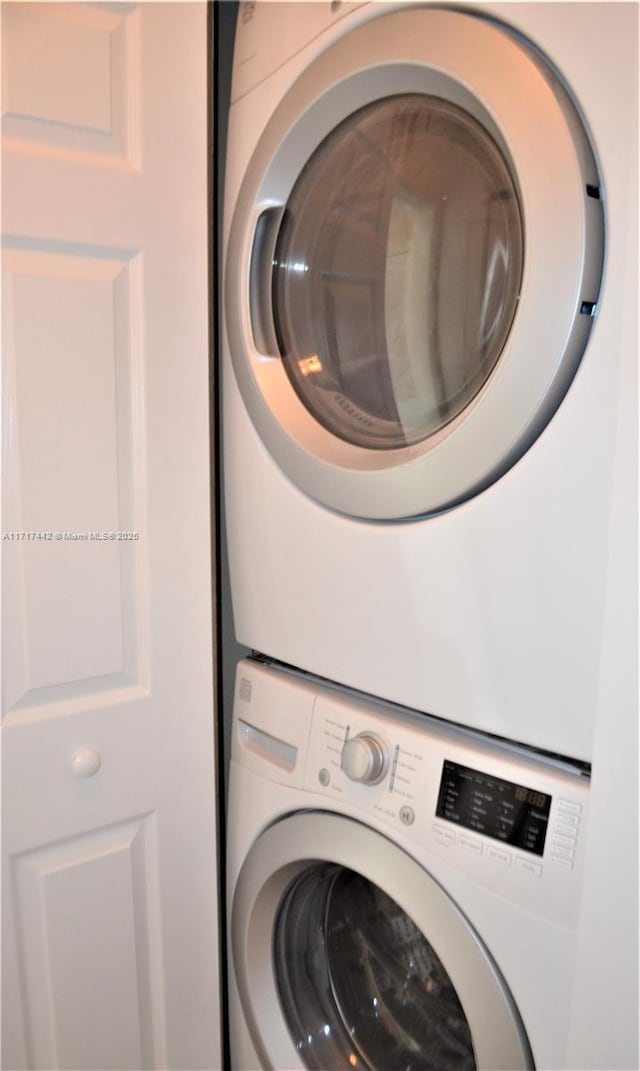 laundry area featuring stacked washing maching and dryer