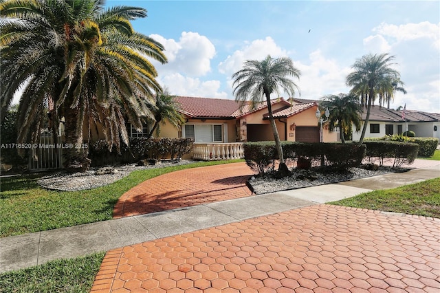 view of front of home featuring covered porch and a garage