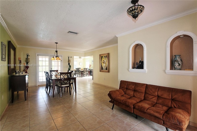 living room featuring light tile patterned floors, a textured ceiling, and ornamental molding