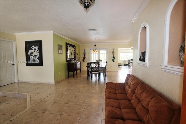 living room featuring ceiling fan, crown molding, and light tile patterned flooring