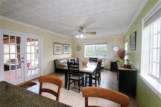 tiled dining space with french doors, a textured ceiling, ceiling fan, and crown molding