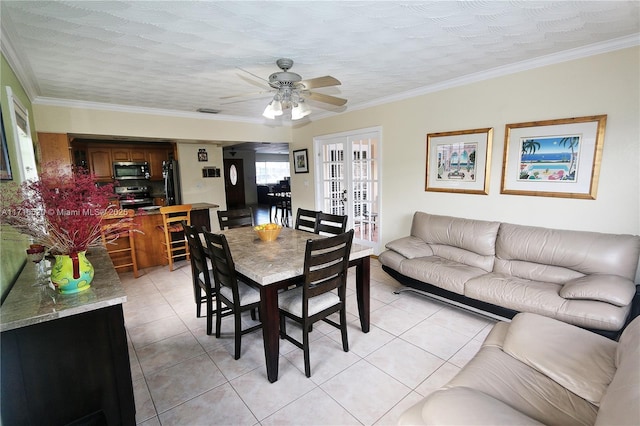 dining room with french doors, a textured ceiling, ornamental molding, and light tile patterned flooring