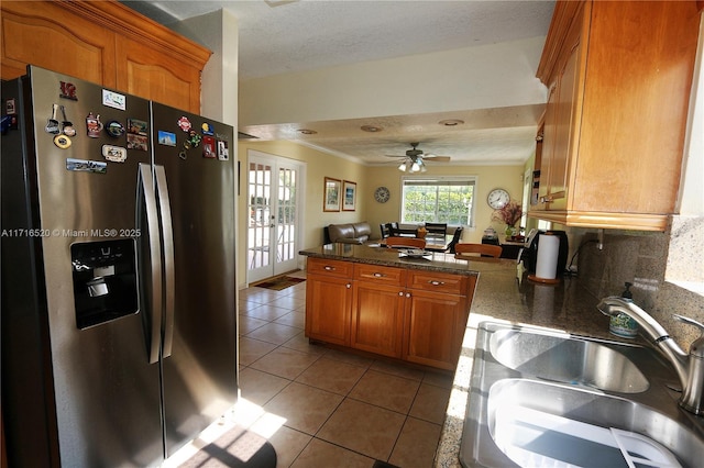 kitchen featuring ceiling fan, french doors, sink, stainless steel refrigerator with ice dispenser, and light tile patterned floors