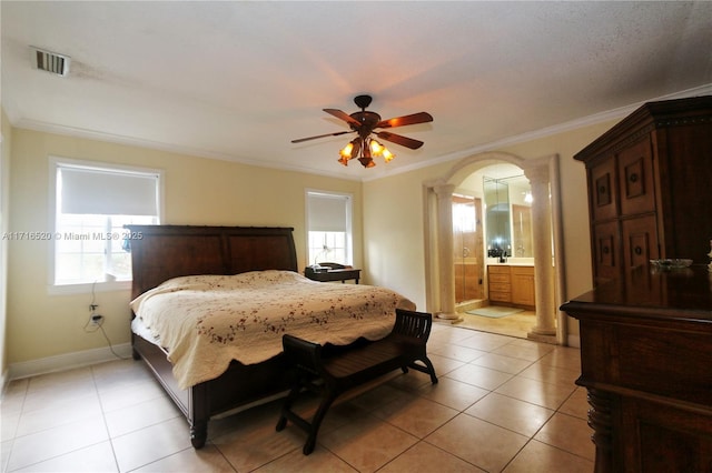 tiled bedroom featuring connected bathroom, ceiling fan, multiple windows, and ornamental molding