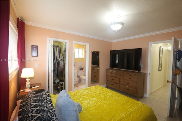 bedroom featuring a walk in closet, ensuite bath, ornamental molding, light tile patterned flooring, and a closet