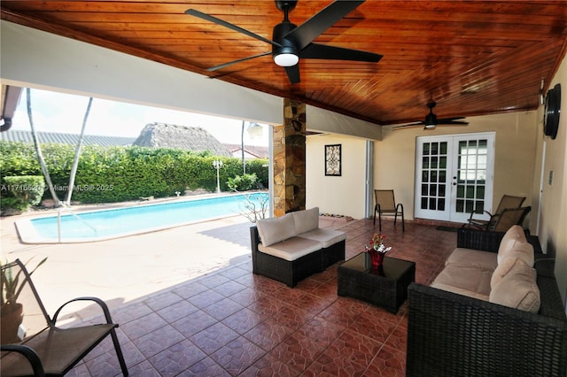 view of patio / terrace featuring a fenced in pool, outdoor lounge area, a mountain view, and french doors