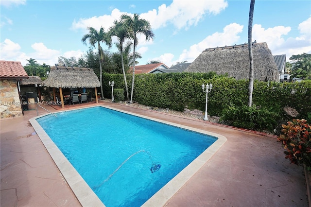 view of swimming pool with a gazebo and a patio area