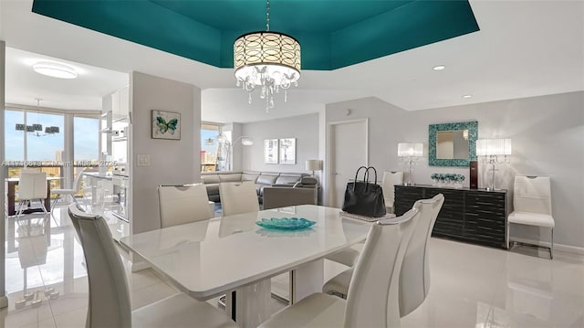 tiled dining room with a chandelier and expansive windows