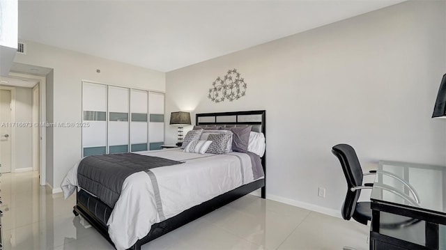 tiled bedroom with a closet