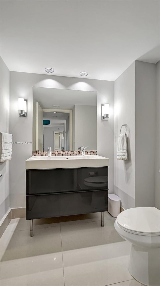 bathroom with tile patterned floors, vanity, and toilet