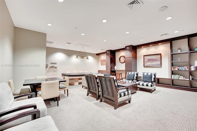 living room featuring built in features and light colored carpet