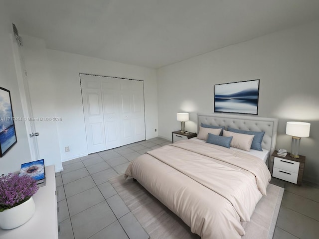 bedroom with tile patterned floors and a closet