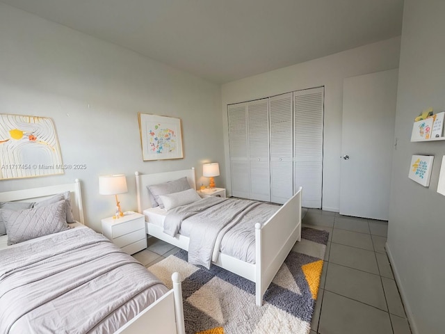 tiled bedroom with a closet