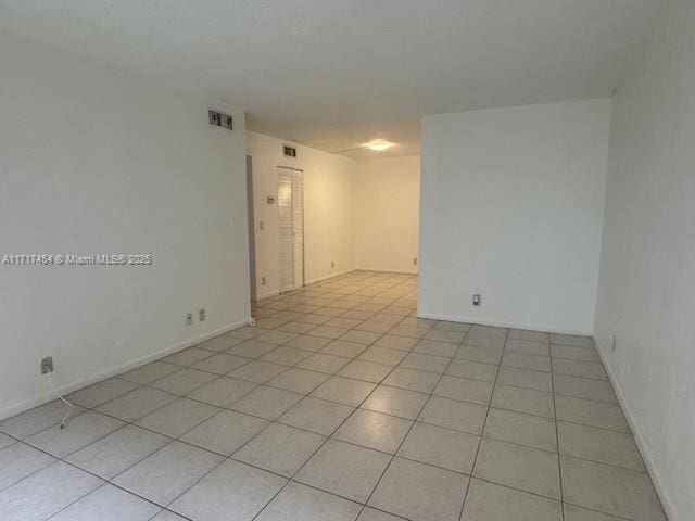 spare room featuring light tile patterned floors