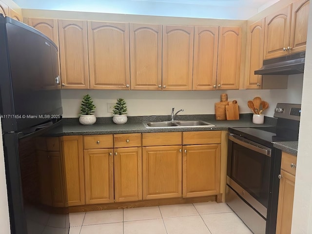 kitchen with stainless steel electric range oven, sink, refrigerator, and light tile patterned floors