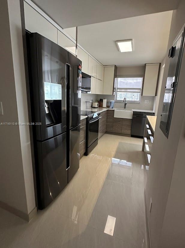 kitchen with sink and black appliances