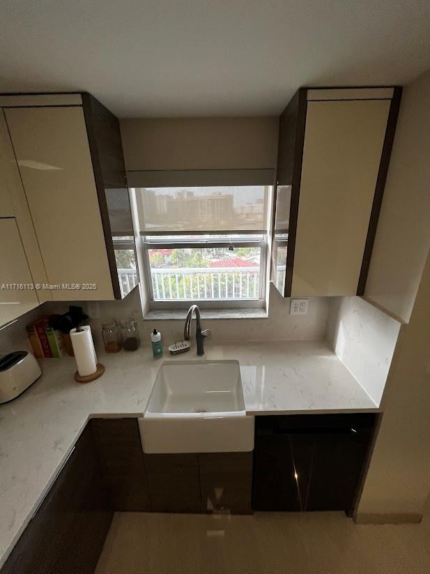 kitchen with light stone countertops and sink