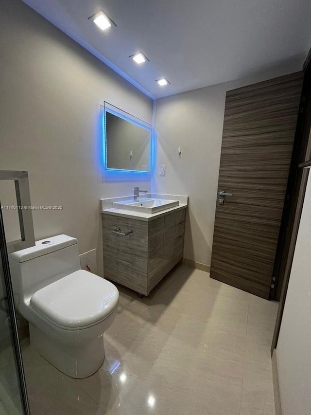 bathroom featuring vanity and toilet