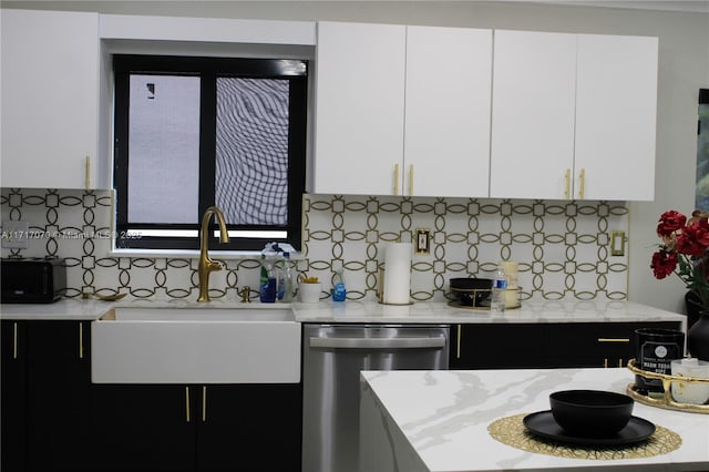 kitchen with tasteful backsplash, white cabinetry, sink, and stainless steel dishwasher