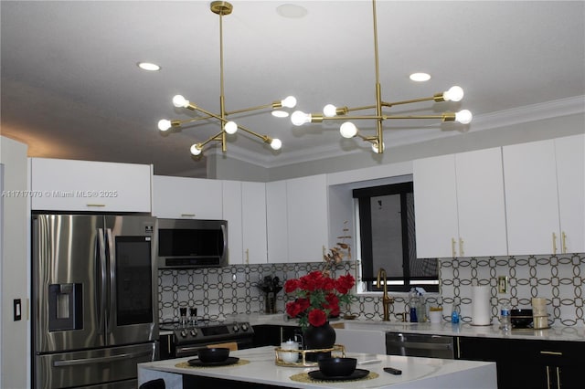 kitchen featuring decorative backsplash, stainless steel appliances, an inviting chandelier, white cabinetry, and hanging light fixtures