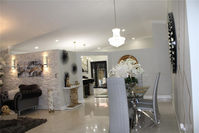 dining room featuring crown molding, light tile patterned floors, and an inviting chandelier