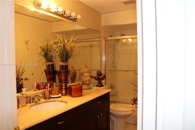 full bathroom featuring vanity, toilet, and enclosed tub / shower combo