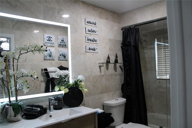 full bathroom with shower / tub combo, vanity, toilet, and tile walls