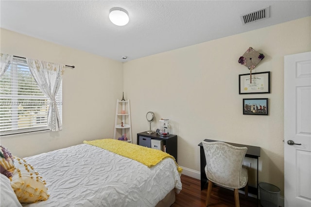 bedroom with dark hardwood / wood-style flooring