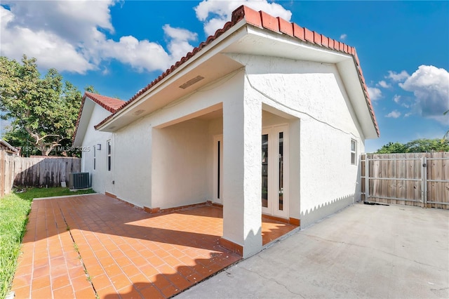 exterior space with central AC unit and a patio area