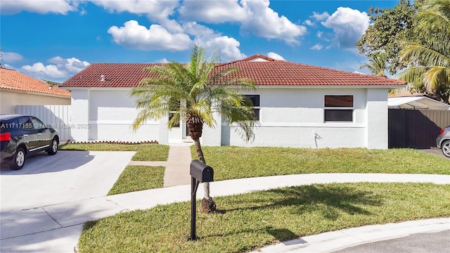 mediterranean / spanish house featuring a front lawn