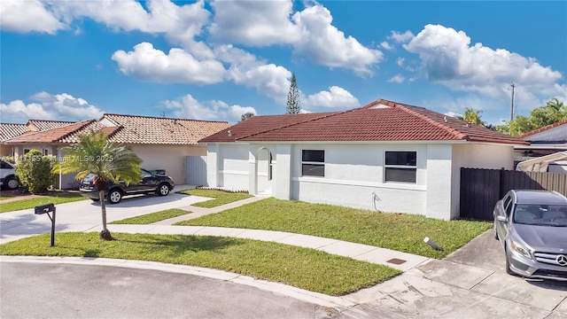 mediterranean / spanish-style house with a front lawn