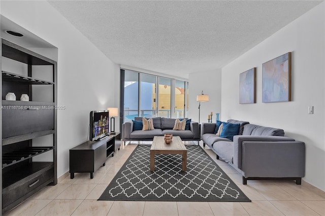 tiled living room featuring expansive windows and a textured ceiling