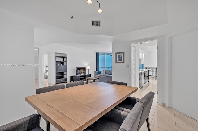 dining space featuring built in features and light tile patterned floors