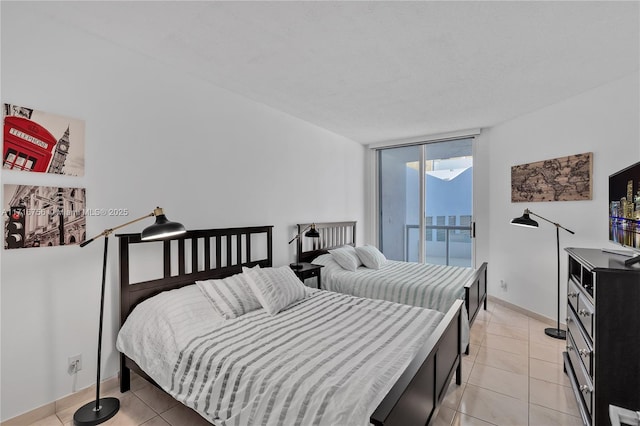 tiled bedroom with access to exterior and expansive windows