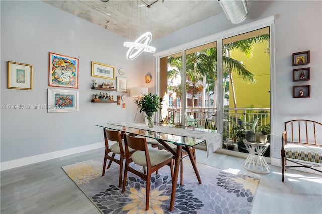 dining room with hardwood / wood-style flooring and a notable chandelier