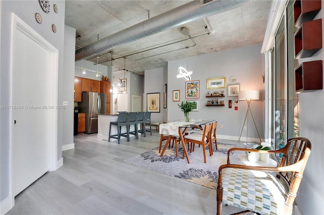 dining area featuring track lighting and light hardwood / wood-style floors