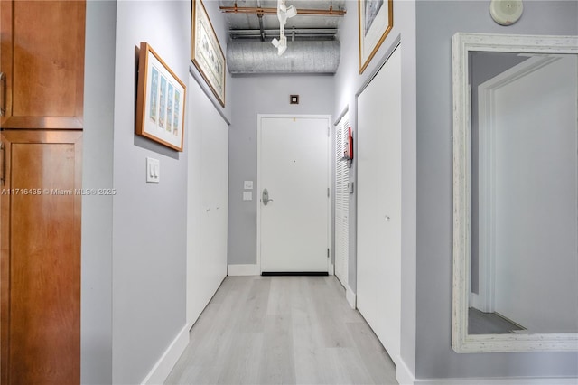 hallway with light hardwood / wood-style floors