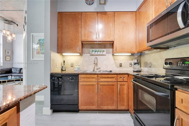 kitchen featuring sink, backsplash, black appliances, and light stone countertops