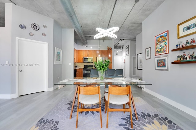 dining space featuring light wood-type flooring