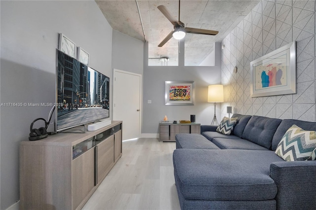 living room with light hardwood / wood-style floors and ceiling fan