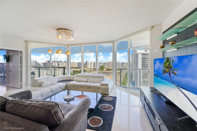 living room featuring a notable chandelier, floor to ceiling windows, and a textured ceiling