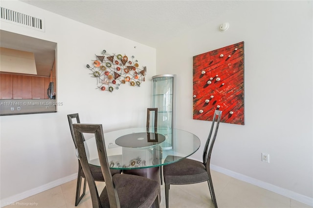 dining space featuring light tile patterned flooring