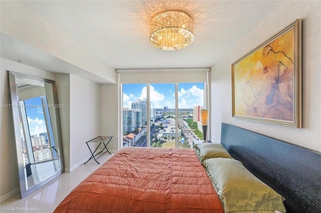 bedroom with a textured ceiling, a wall of windows, and multiple windows