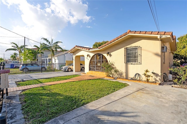 mediterranean / spanish-style home featuring a front yard