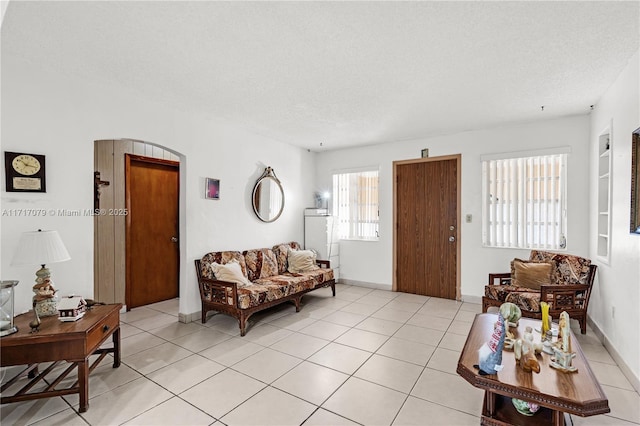 living room with light tile patterned floors and a textured ceiling