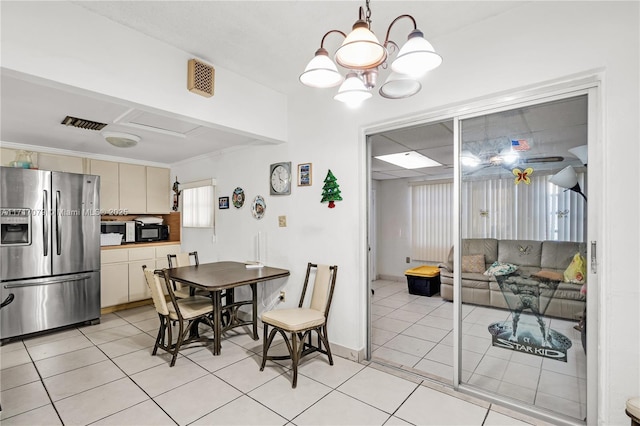 dining area with a notable chandelier and light tile patterned flooring