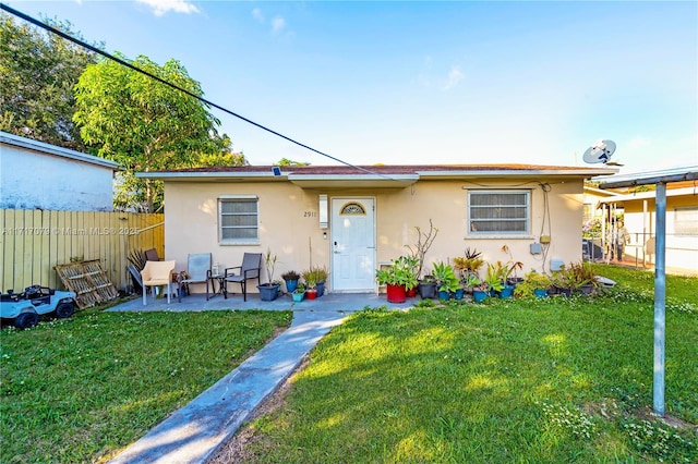 view of front of property with a patio area and a front yard