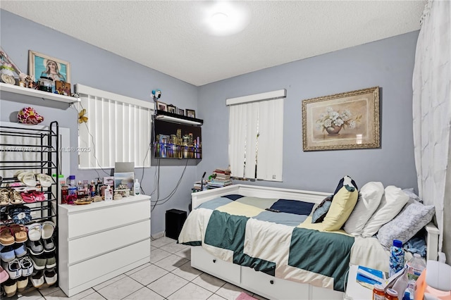 tiled bedroom featuring a textured ceiling