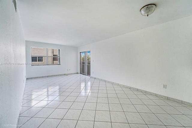 empty room with light tile patterned floors